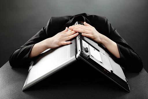 Person with head buried under a laptop